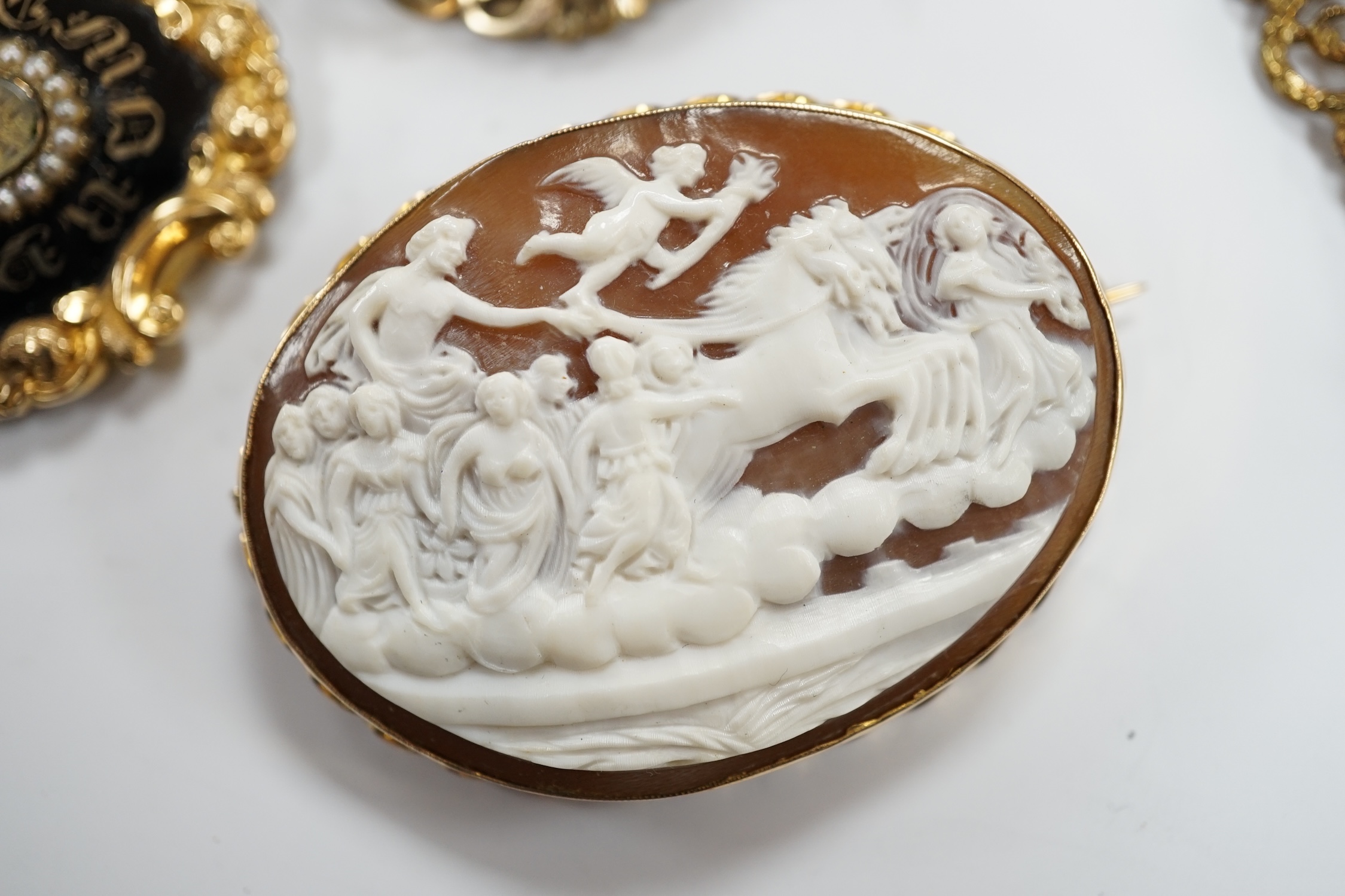 Three assorted Victorian mourning brooches, including two yellow metal, one set with seed pearls and diamond chip and inscribed and dated 1847, 48mm and two cameo shell set brooches.